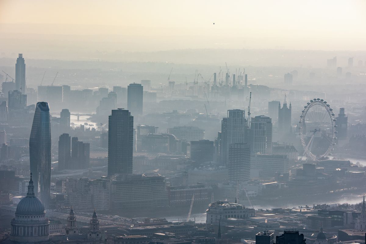 Misty aerial view over St.Paul's and Southbank, London Eye, with Battersea in far distance, London. 4560